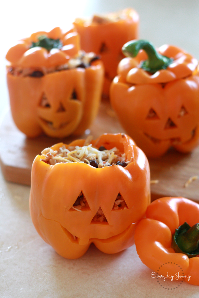 Stuffed peppers with shredded chicken, black beans and Mexican rice. Great for a Halloween dinner. Recipe at everydayjenny.com