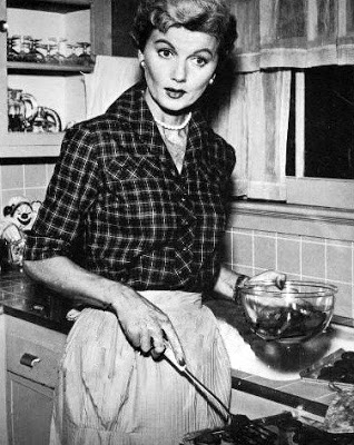 June Cleaver wearing an apron
