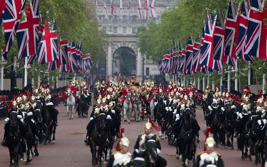 The coaches flanked and the Household Cavalry travel down The Mall towards Buckingham Palace