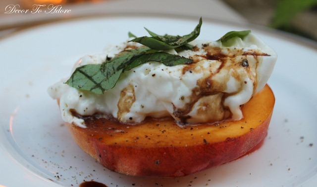 red tomato and peach topped with burrata