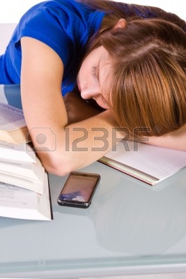 College Student Falling Asleep while Studying for her Finals - Isolated Background Stock Photo - 6802628