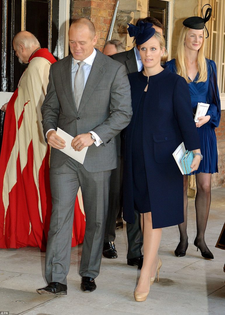 Prince George's godmother Zara Tindall, seen here with rugby-playing husband Mike, was chic in navy at the royal christening today - behind her is William van Cutsem's wife, Rosie