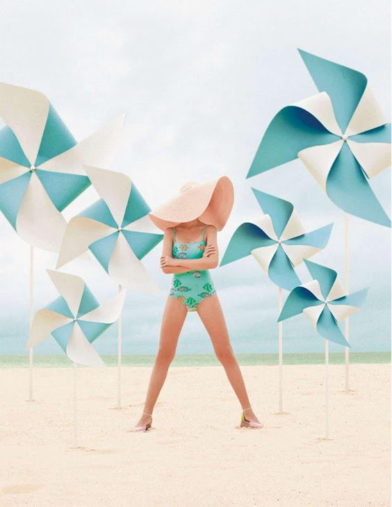 lovely teal, aqua, turquoise pinwheels on beach. Love the floppy hat with the aqua swimsuit: 