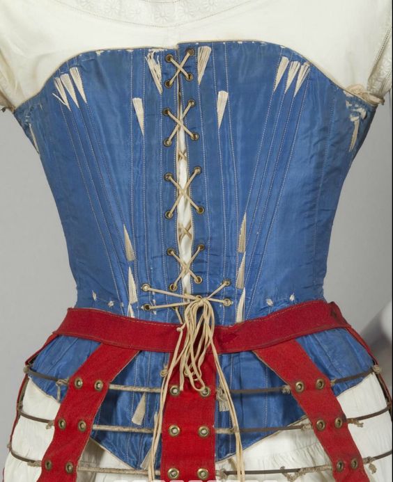 1860s blue silk corset. Steel bones and busk, brass hardware, cream cotton