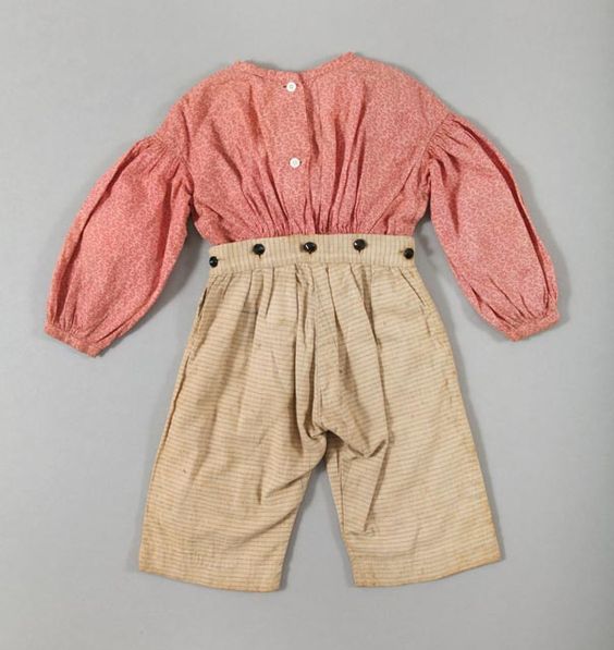 Boy’s outfit, pink and red calico shirt attached to plaid tan blue and gray patterned pants, hand-sewn, cotton and wooden buttons, circa 1840.: 