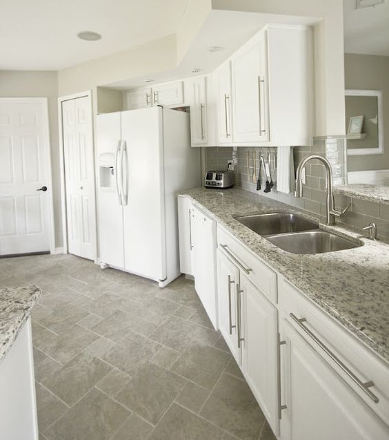 Kitchen with white appliances. Love the grey floor and the glass subway tile backsplash: 
