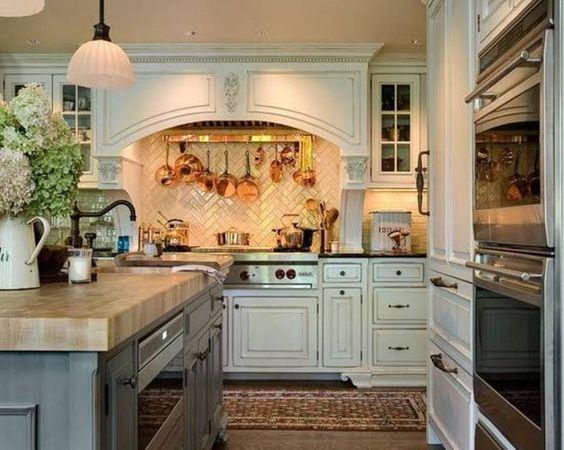 english-country-kitchen-with-white-cabinets-and-wall-mounted-pot-rack-over-range.jpg 