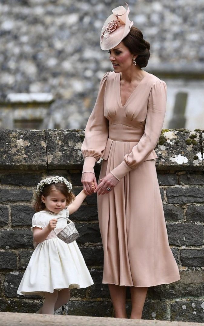 The Duchess of Cambridge stands with her daughter Britain's princess Charlotte, a bridesmaid