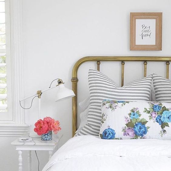 Studio McGee on Instagram: “How sweet is our niece's room styled with #studiomcgeehc gray striped pillows? Her brass bed and vintage floral fabric are too cute for me to handle! Thanks @amymcgee ”: 