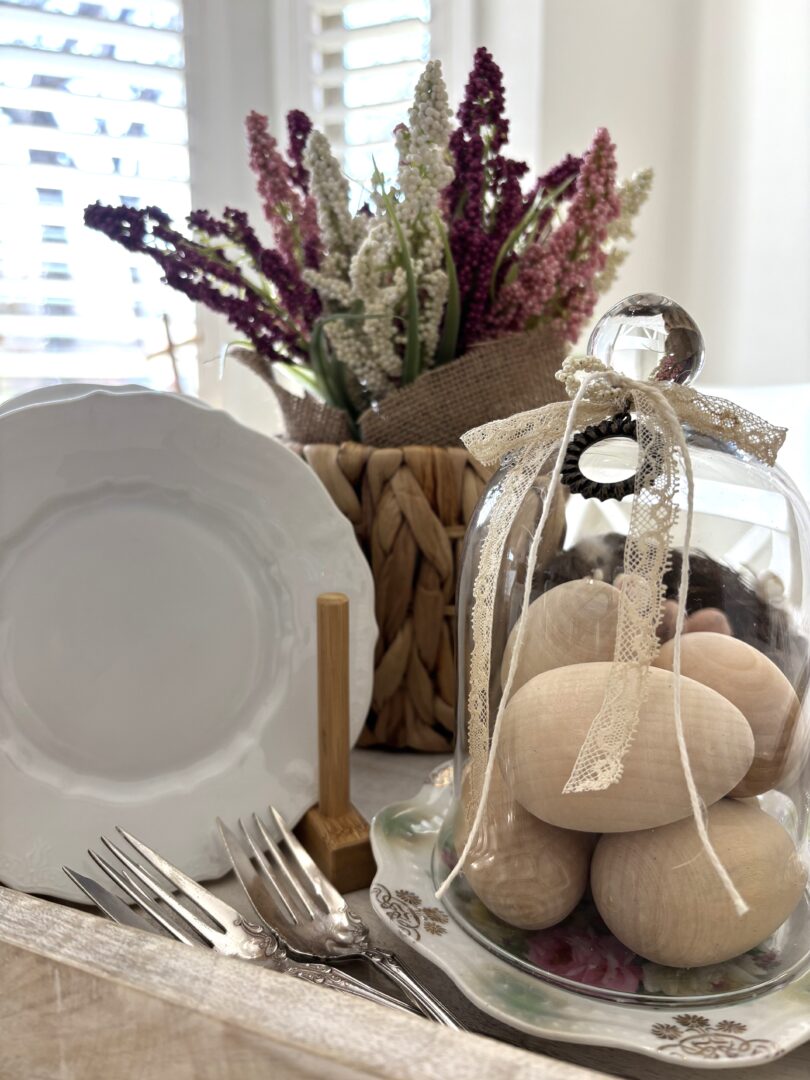 Wooden eggs under a cloche