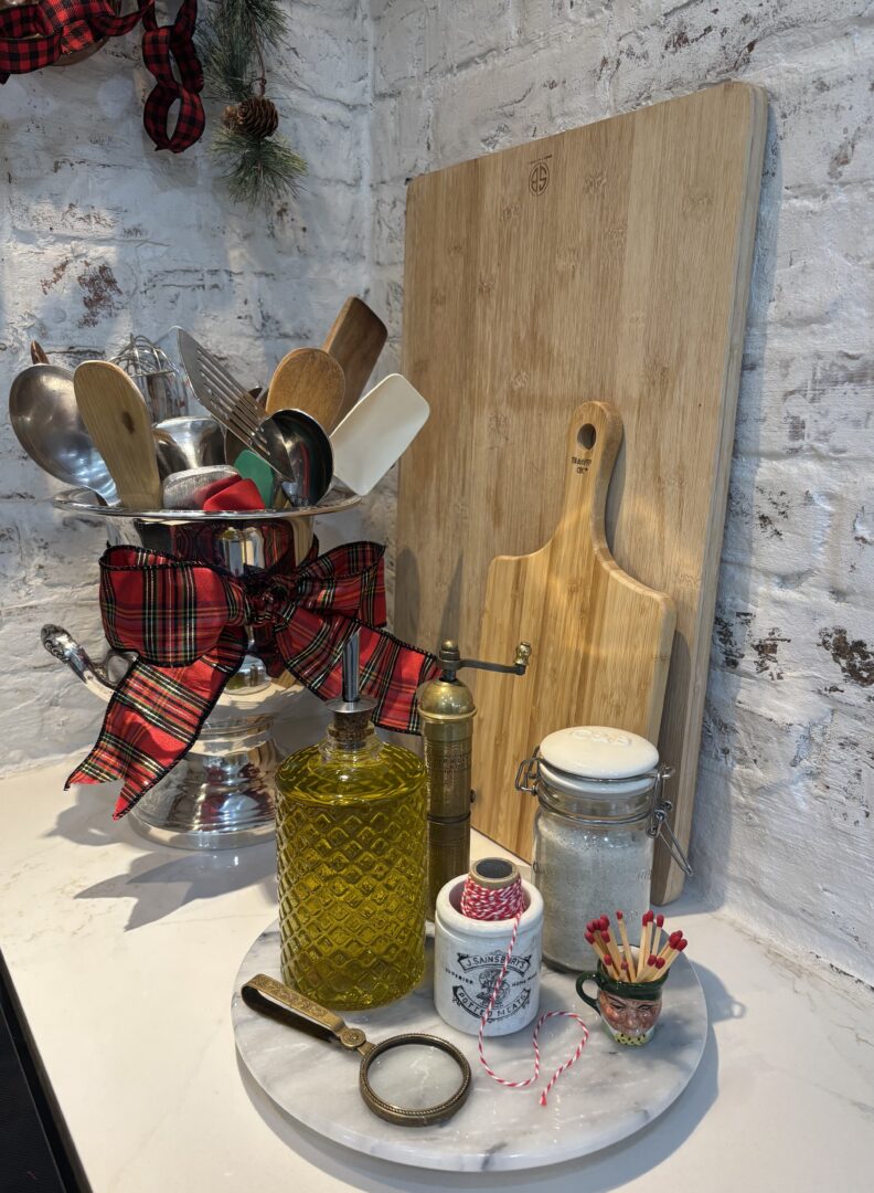 Silver urn holds wooden spoons. 